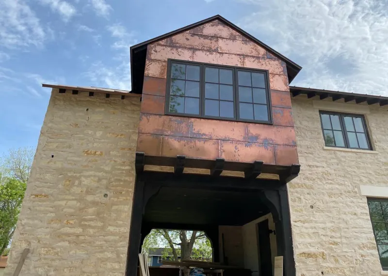 Copper metal panel facade on a stone building for Skylight Installation in Kenai